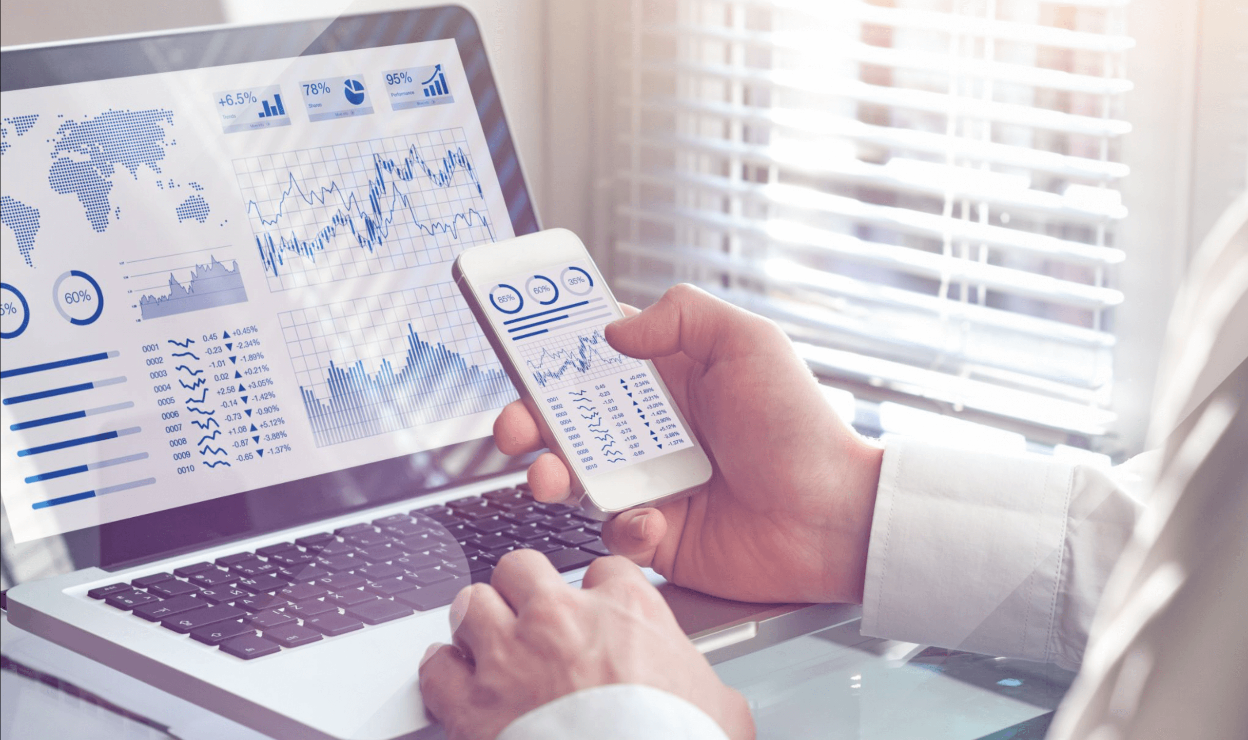 man looking at analytics on phone and laptop representing Digital Marketing Metrics