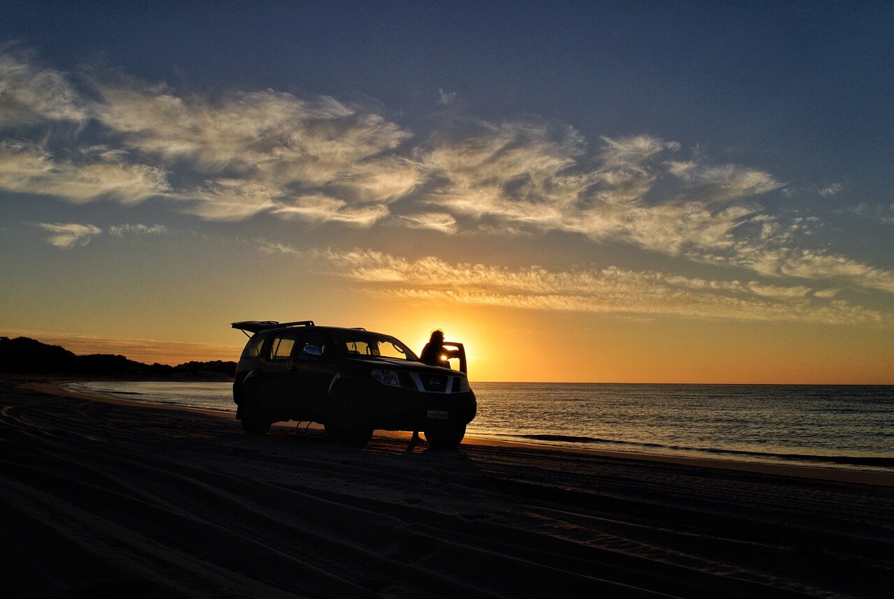 sunset with car on the beach